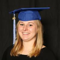 student posing in graduation cap for a picture